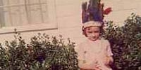 Sarah as a child wearing Indian chief headdress