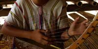 A student learning to play the Thana in Mae La refugee camp