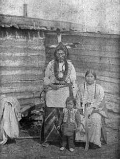 Standing in front of log building