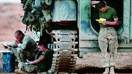 Detail of Operation Homecoming book cover; troops around tank writing